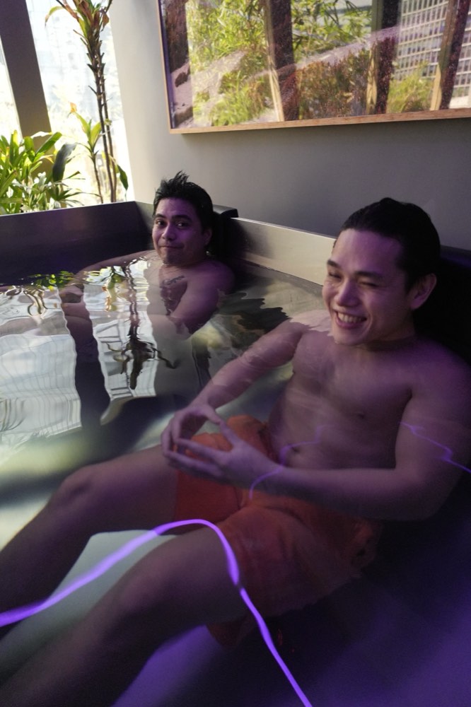 Two guests laughing in the cold plunge