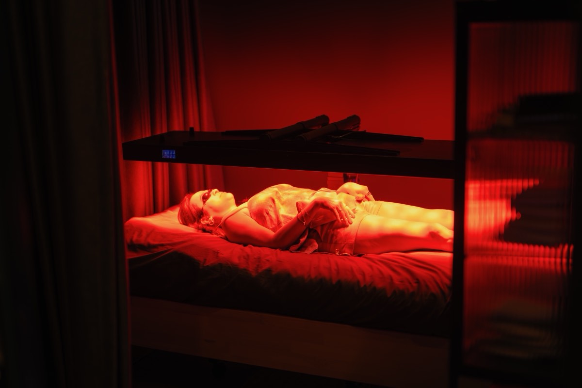 Guest resting under the red light panels